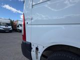 the rear end of a white van parked in a parking lot