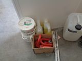 a box of red hoses next to a container of water