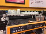 a coffee machine that is on the counter in a coffee shop