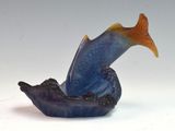 a blue and orange fish figurine sitting on top of a boat