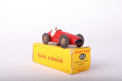 a red toy car sitting on top of a yellow box