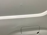 a close up of a white van with a flat tire