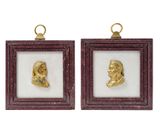 a pair of gold - plated busts of a man and a woman