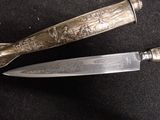 two knives that are sitting next to each other on a table