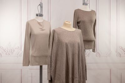 three mannequins of different sizes and colors are on display in a room