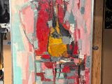 un tableau posé sur un chevalet, représentant une guitare