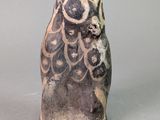 une image représentant une figurine de chouette en céramique sur fond gris