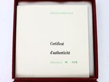 a certificate in a red box on a white surface