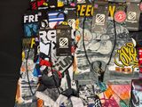 a pile of assorted clothing on a black surface