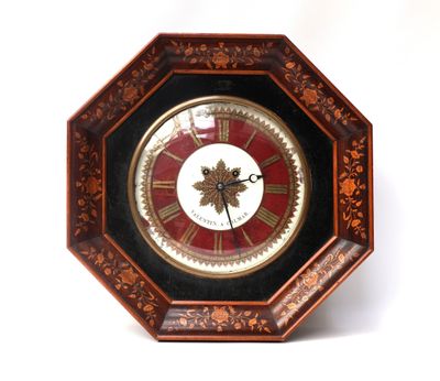 a clock that is sitting on a white surface
