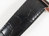 a watch that is sitting on top of a black strap