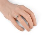 an image of a woman ' s hand with a ring on it
