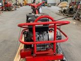 a small engine sitting on a pallet in a warehouse