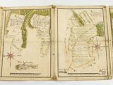 an old map of the world is displayed on a table