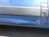 a close up of a car door with the door handle missing
