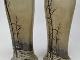 two vases that have been painted with trees on them