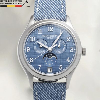 a close up of a wrist watch with a blue dial