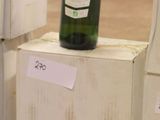 a bottle of wine sitting on top of a wooden box