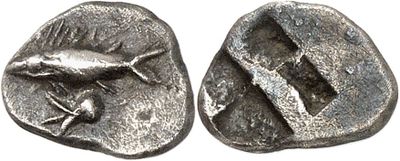 a close up of two silver coins with a bird on them