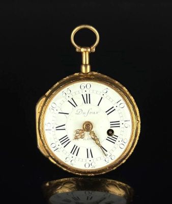 a gold pocket watch with roman numerals on the face