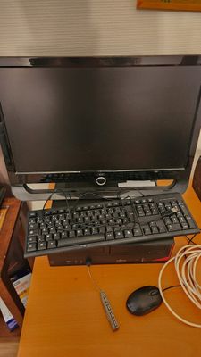 a laptop computer sitting on top of a wooden desk