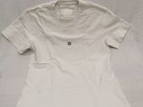 a white shirt sitting on top of a white sheet on a table