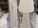 a lamp that is sitting on the floor next to a glass case
