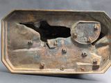 a metal box with a bird on it on a table