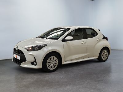 a white toyota yaris parked in a white room
