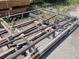 a pile of wood sitting on the ground next to a building