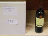 a bottle of wine sitting on a shelf next to a box