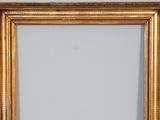 an image of a gold frame on a wall with a white background