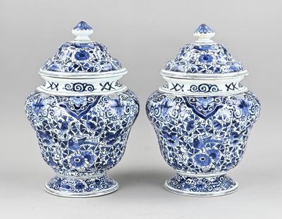pair of blue and white vases with lids on pedestals