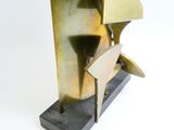 a bronze sculpture of a man with a hat on a stand
