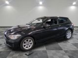 a picture of a black bmw suv parked in a showroom