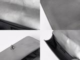 the inside of a silver purse with a zipper on the inside
