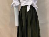 a mannequin wearing a white shirt and green skirt