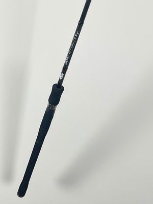 a fishing rod that is standing up on a white surface