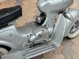 a scooter that is parked on the sidewalk