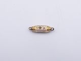 an image of a gold plated metal bead with a blue and white design on it