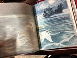 a person holding a book with a picture of a boat in the water