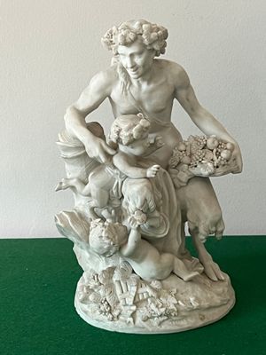 a statue of a man sitting on top of a pile of animals