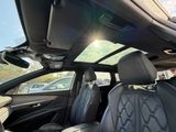 the sun shines brightly through the sunroof over the back seats of a car