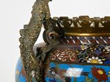 a vase with a peacock on it sitting on a table