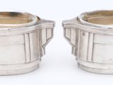 pair of silverplated sugar and creamers on a white background