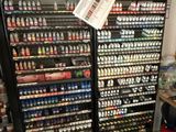 many bottles of paint on the shelves in the store