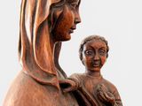 an image of a wooden statue of a woman holding a child