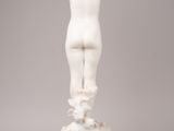 a white marble statue of a boy standing on a cloud