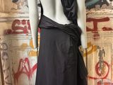 an image of a mannequin wearing a black dress in front of a graffiti covered wall