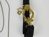 a picture of a watch and a chain on a white surface